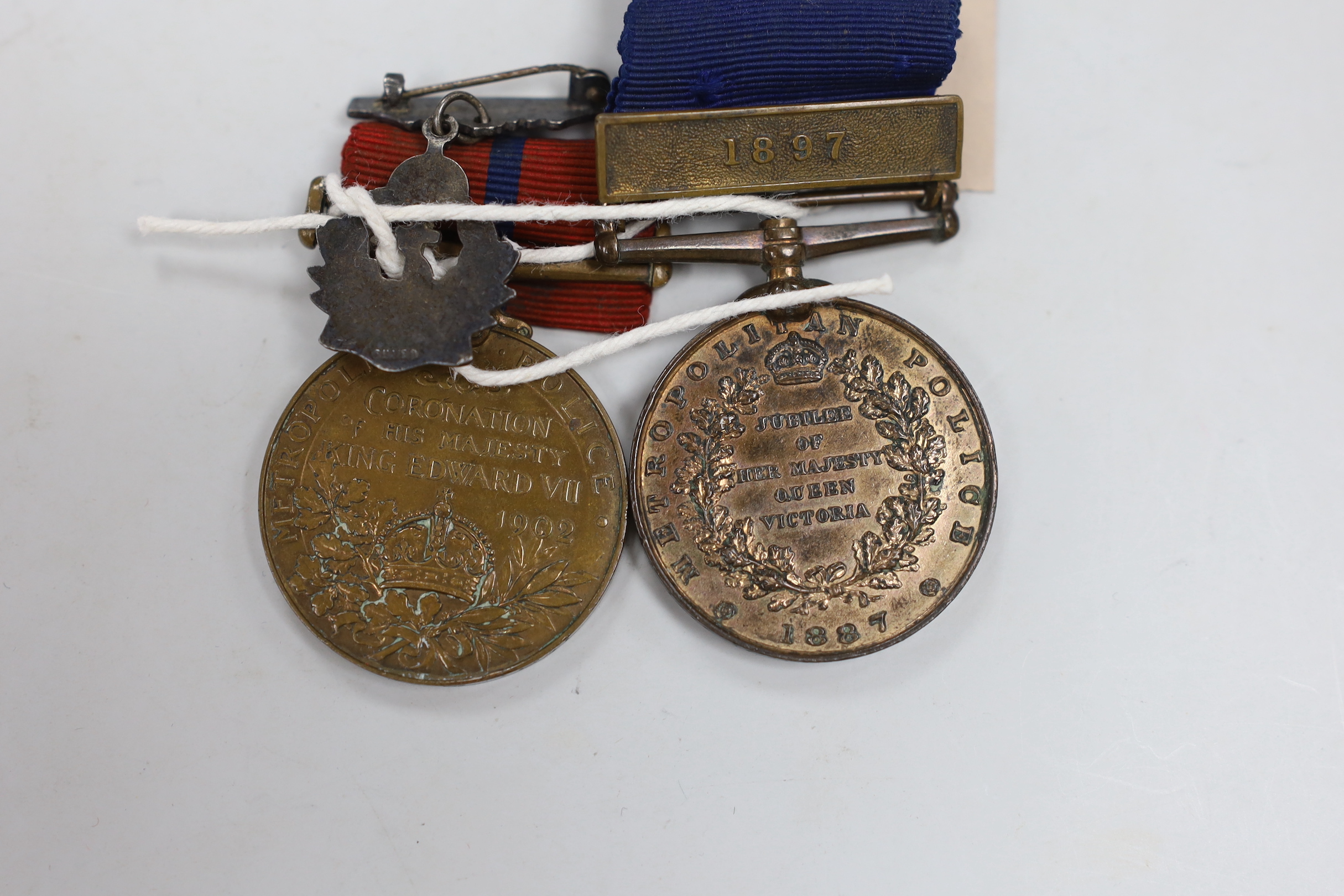 A Metropolitan Police medal, Jubilee 1887 with 1897 clasp named to PC. N. Symonds, D-Division, and Metropolitan Police medal, Coronation Edward VII 1902, named to PS N. Simmonds, A Division, together with a silver and en